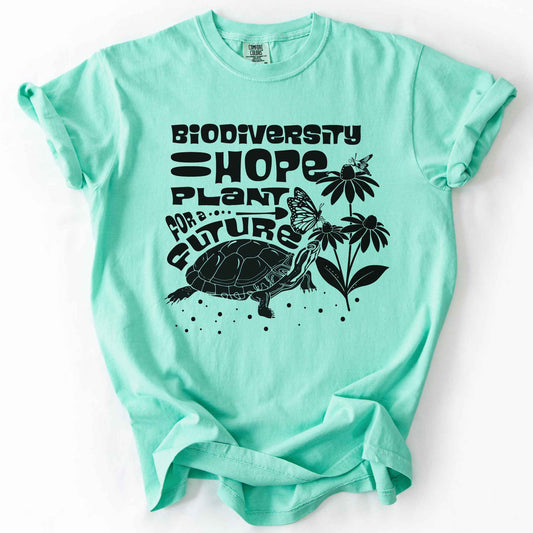 Island reef "Biodiversity Hope, Plant for a Future" t-shirt on Comfort Colors tee, featuring a black graphic of a turtle with monarch butterflies on coneflowers in bold groovy lettering. Conservation and native plant gift shirt for wildlife and biodiversity enthusiasts.