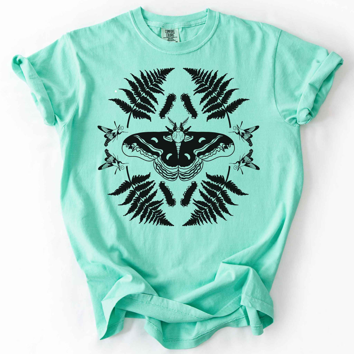 Island reef "Cecropia moth" t-shirt on Comfort Colors tee, featuring a bold black symmetrical design of a moth surrounded by ferns and hummingbird moths in a mirrored botanical pattern. Nature lover and moth enthusiast gift shirt for entomology and cottagecore fans.