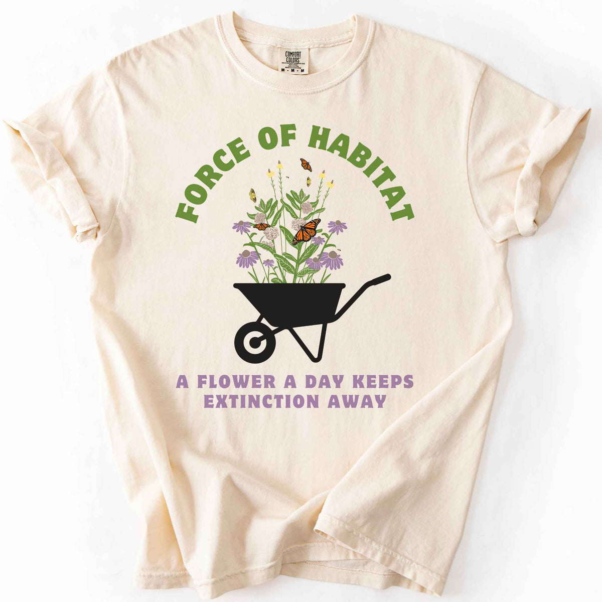 Ivory "Force of Habitat, A Flower a Day Keeps Extinction Away" t-shirt on Comfort Colors tee, featuring a wheelbarrow overflowing with coneflowers and monarch butterflies. Gardener and native plant gift shirt for pollinator conservation and habitat restoration fans.
