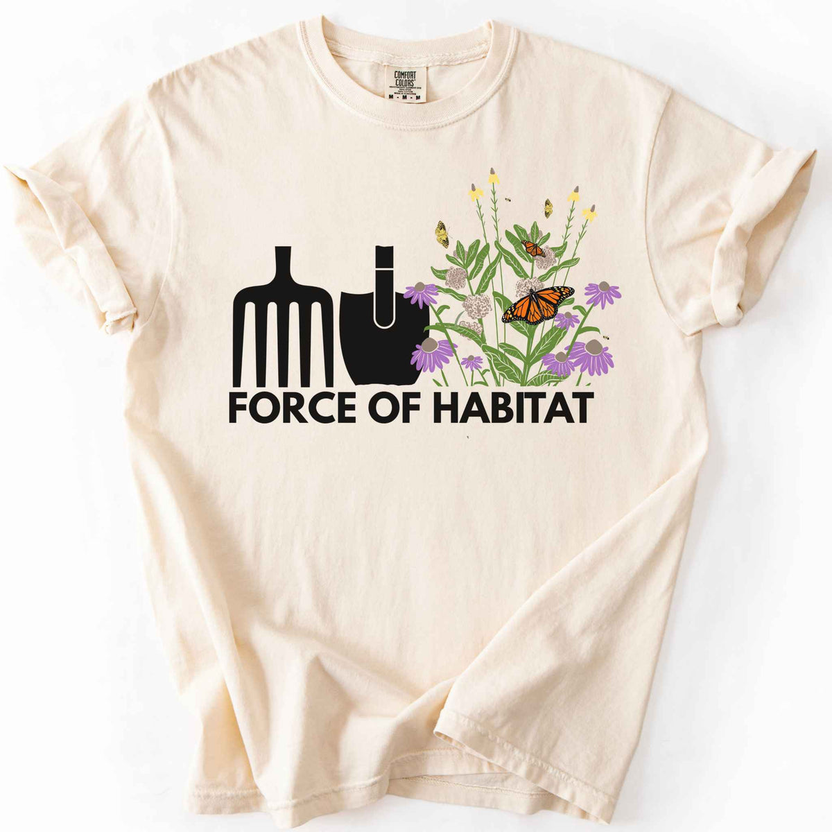 Ivory "Force of Habitat" t-shirt on Comfort Colors tee, featuring simple garden tool graphics beside a coneflower and milkweed patch with monarch and fritillary butterflies. Gardener and native plant gift shirt for pollinator conservation fans.
