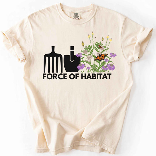 Ivory "Force of Habitat" t-shirt on Comfort Colors tee, featuring simple garden tool graphics beside a coneflower and milkweed patch with monarch and fritillary butterflies. Gardener and native plant gift shirt for pollinator conservation fans.