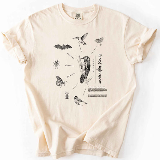 Ivory "Forest Influencer" t-shirt on Comfort Colors tee, featuring a vintage style Yellow bellied Sapsucker illustration surrounded by the beetles, moths, bats, and birds it supports, with educational text detailing its ecological role. Nature lover and birding gift shirt for wildlife and forest ecology fans.
