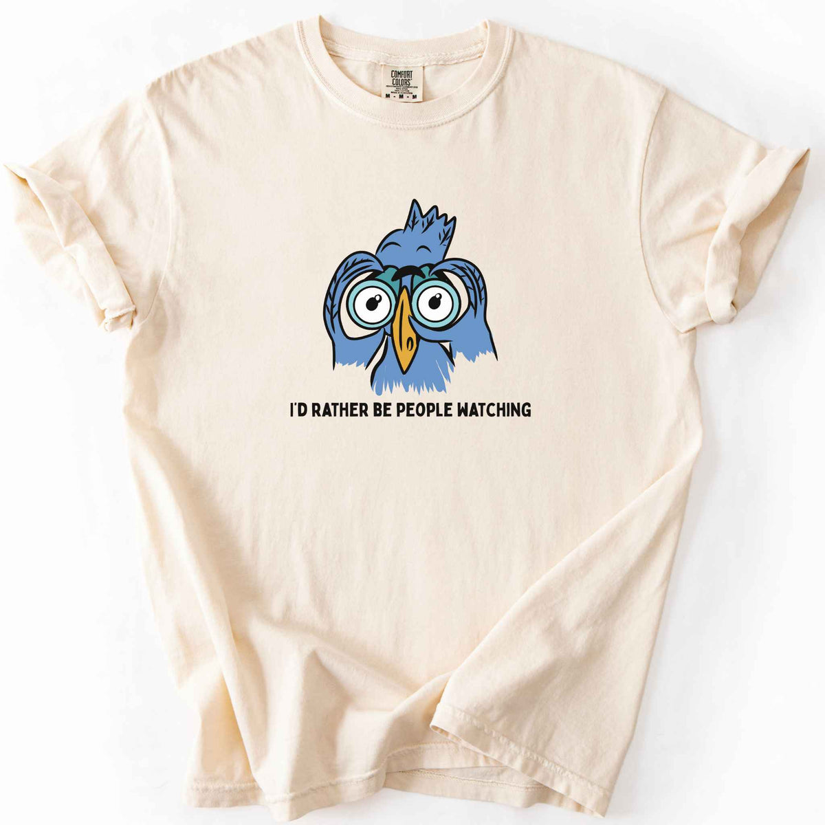 Ivory "I'd Rather Be People Watching" t-shirt on Comfort Colors tee, featuring a cartoon blue bird holding binoculars up to its eyes. Funny birdwatcher gift shirt for bird lovers and introverts.