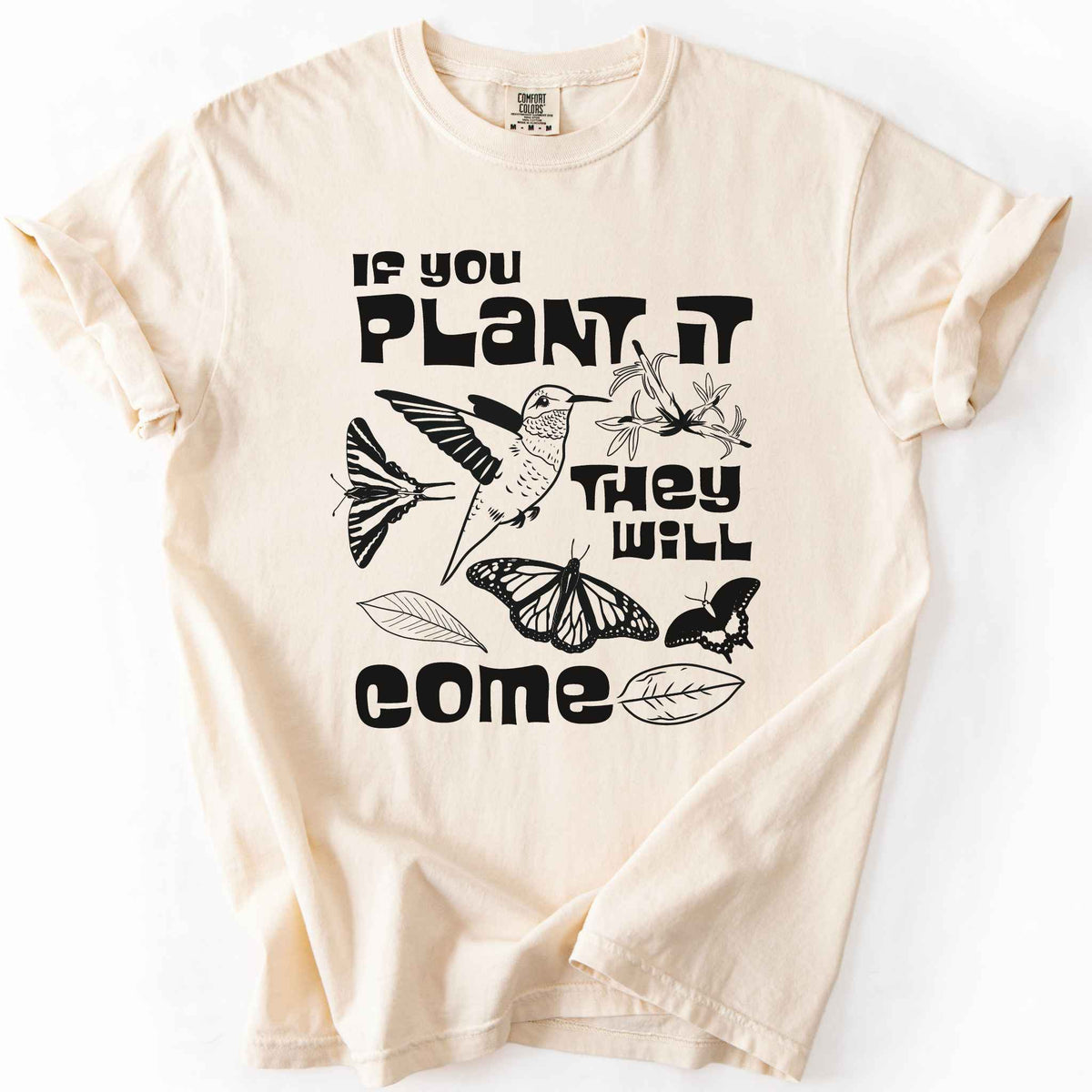Ivory "If You Plant It, They Will Come" t-shirt on Comfort Colors tee, featuring a hummingbird surrounded by butterflies and flowers with bold black lettering and line art style. Gardener and native plant gift shirt for pollinator conservation fans.