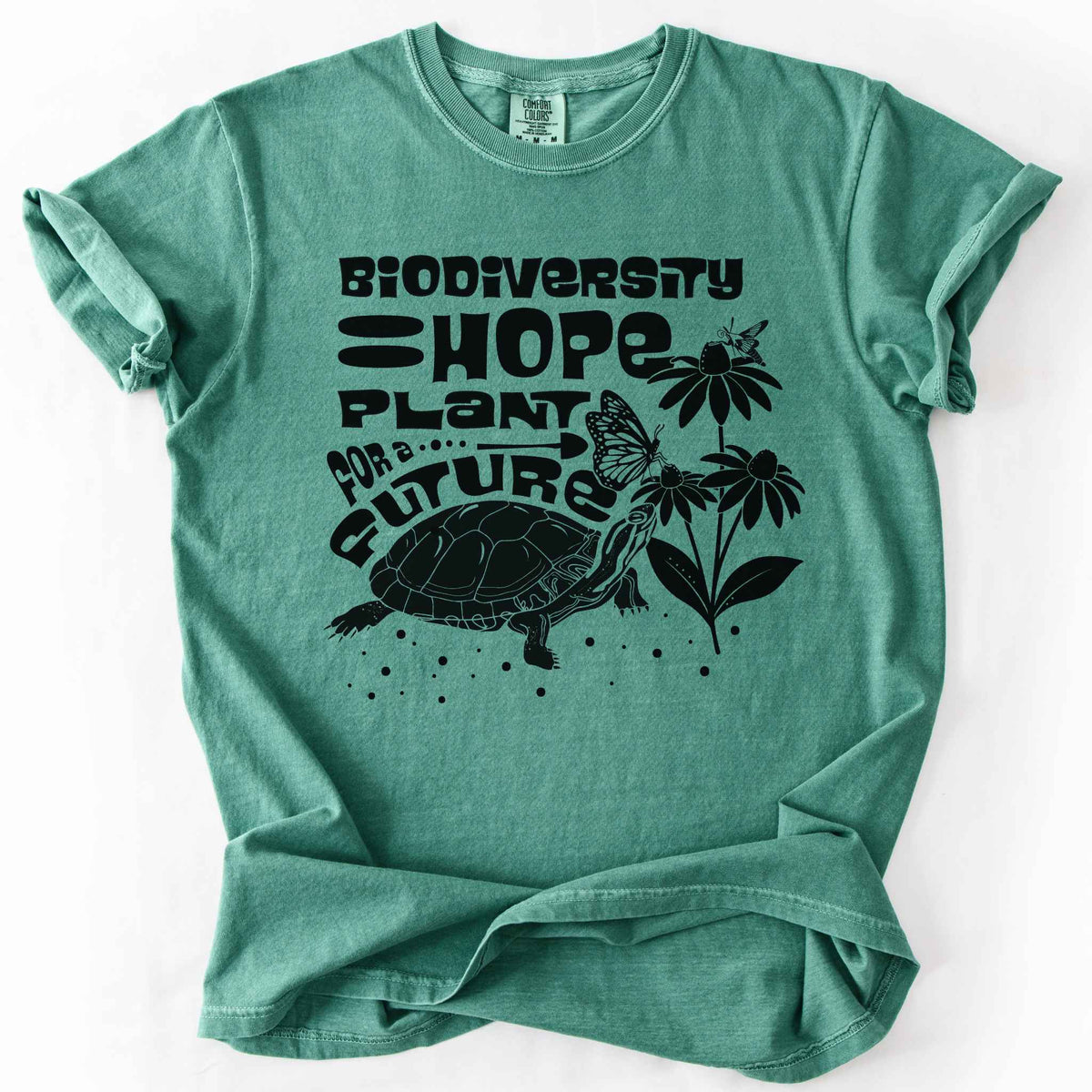 Light green "Biodiversity Hope, Plant for a Future" t-shirt on Comfort Colors tee, featuring a black graphic of a turtle with monarch butterflies on coneflowers in bold groovy lettering. Conservation and native plant gift shirt for wildlife and biodiversity.