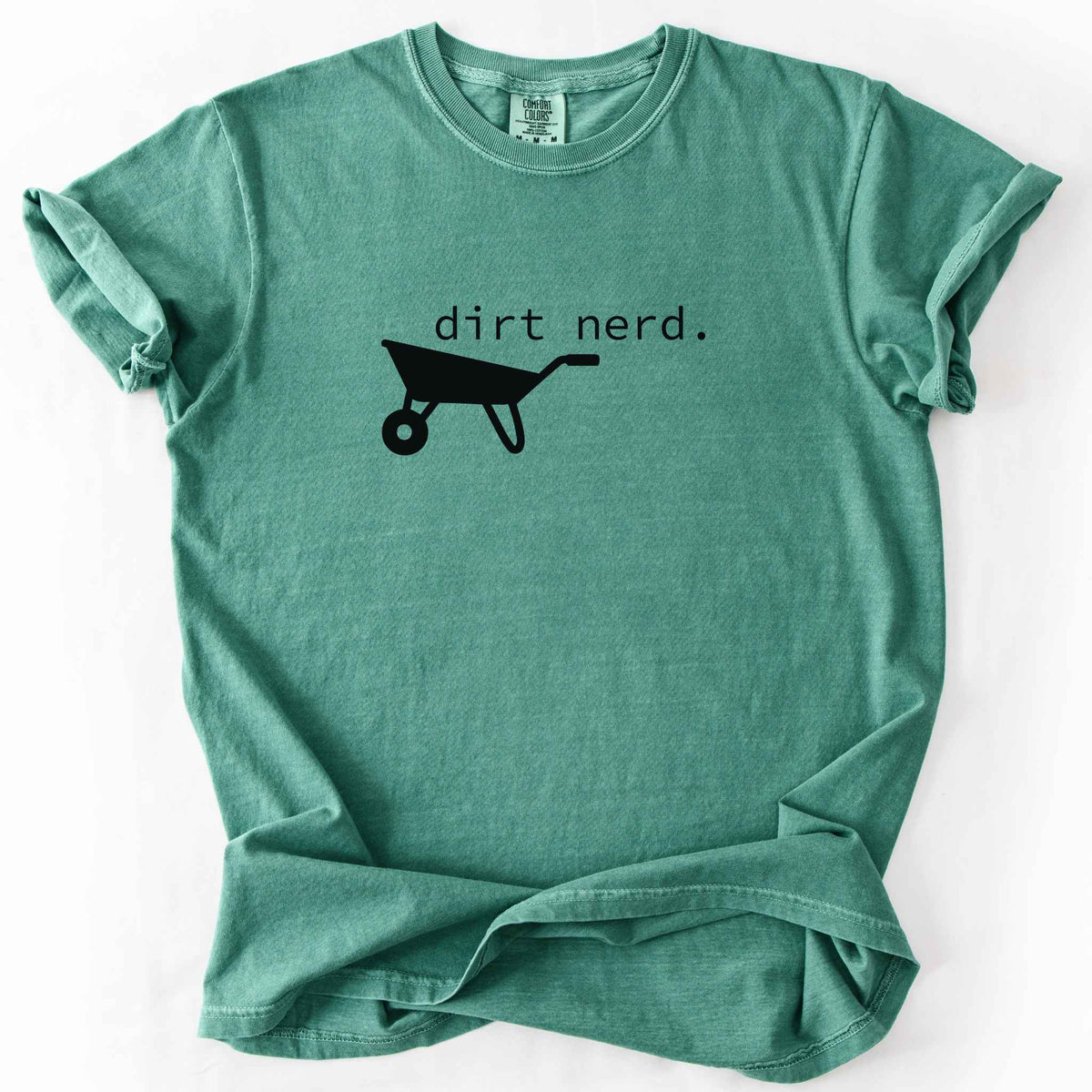 Light green "Dirt Nerd" t-shirt on Comfort Colors tee, featuring a simple black wheelbarrow icon with minimalist typewriter style text. Funny gardener gift shirt for plant lovers and landscaping enthusiasts.