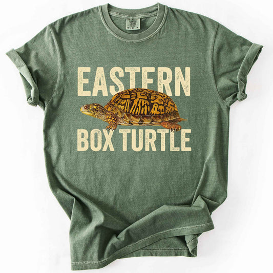 Moss "Eastern Box Turtle" t-shirt on Comfort Colors tee, featuring a detailed vintage style turtle graphic with cream bold block lettering. Reptile lover and turtle enthusiast gift shirt for wildlife and nature fans.