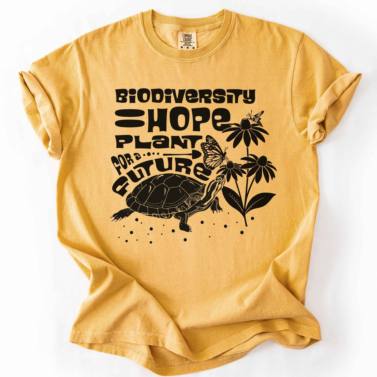 Mustard "Biodiversity Hope, Plant for a Future" t-shirt on Comfort Colors tee, featuring a black graphic of a turtle with monarch butterflies on coneflowers in bold groovy lettering. Conservation and native plant gift shirt for wildlife and biodiversity.