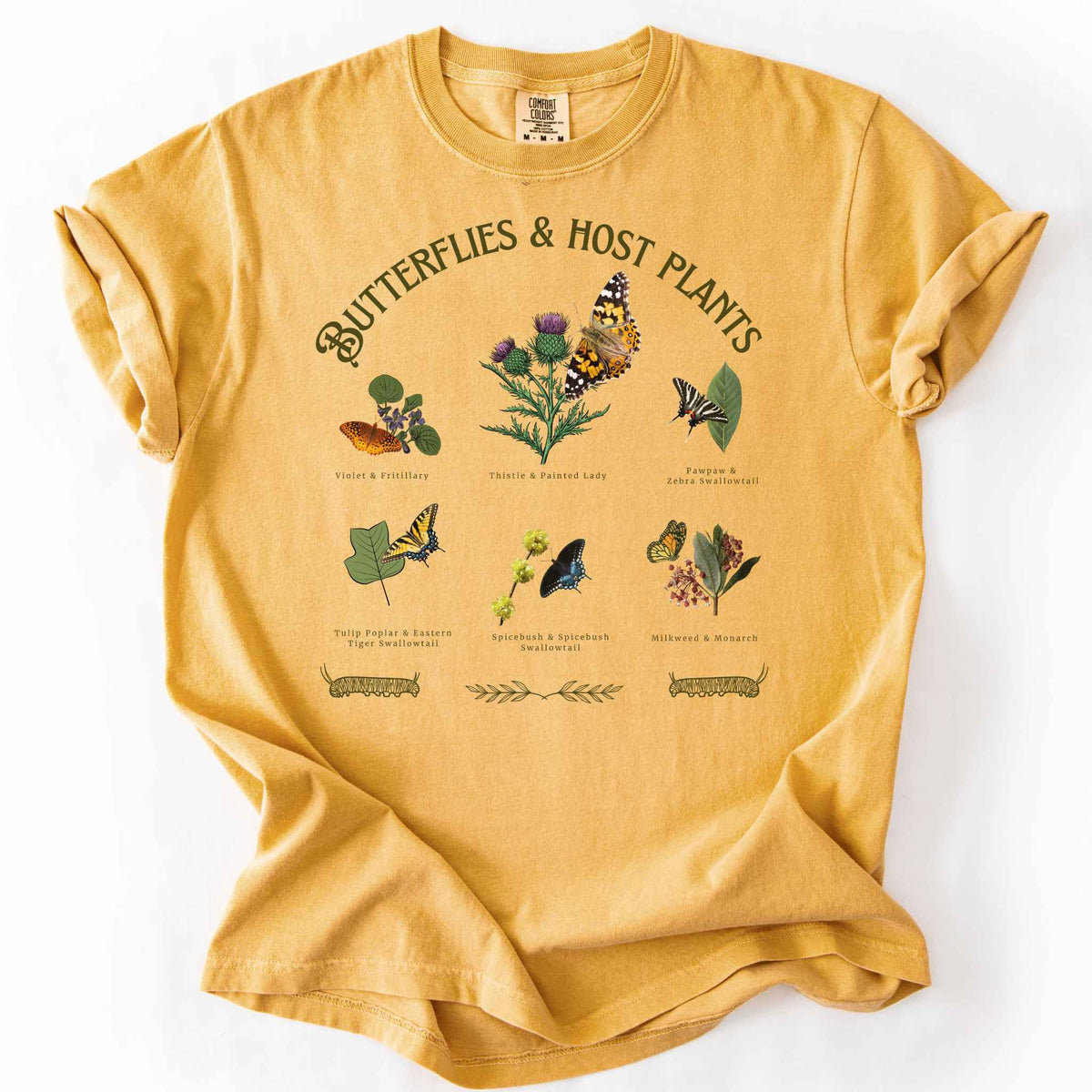 Mustard "Butterflies & Host Plants" t-shirt on Comfort Colors tee, featuring six graphic designed butterfly and plant pairings including Monarch on Milkweed, Painted Lady on Thistle, and Eastern Tiger Swallowtail on Tulip Poplar. Botanical gift shirt for butterfly gardeners and nature lovers.
