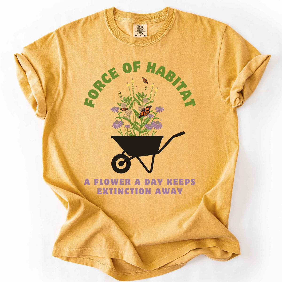 Mustard "Force of Habitat, A Flower a Day Keeps Extinction Away" t-shirt on Comfort Colors tee, featuring a wheelbarrow overflowing with coneflowers and monarch butterflies. Gardener and native plant gift shirt for pollinator conservation and habitat restoration fans.