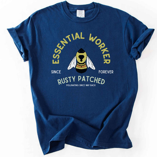 Navy "Essential Worker, Rusty Patched, Pollinating Since Way Back" t-shirt on Comfort Colors tee, featuring an illustrated bumblebee in a circular design. Funny bee lover gift shirt for pollinator and rusty patched bumblebee conservation fans.