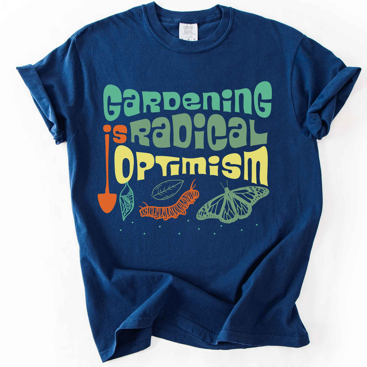 Navy "Gardening Is Radical Optimism" t-shirt on Comfort Colors tee, featuring a butterfly life cycle illustration with a garden shovel and retro lettering. Gardener and native plant gift shirt for pollinator and butterfly conservation fans.