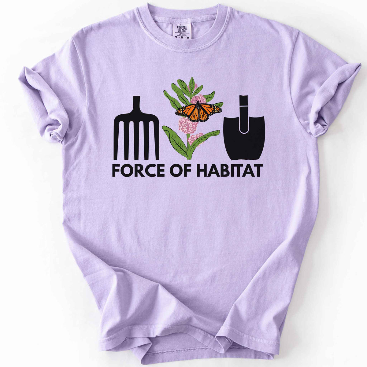 Orchid "Force of Habitat: monarch" t-shirt on Comfort Colors tee, featuring garden tool graphics flanking a hand-drawn monarch butterfly on milkweed flowers with bold black text below. Gardener and native plant gift shirt for pollinator conservation fans.