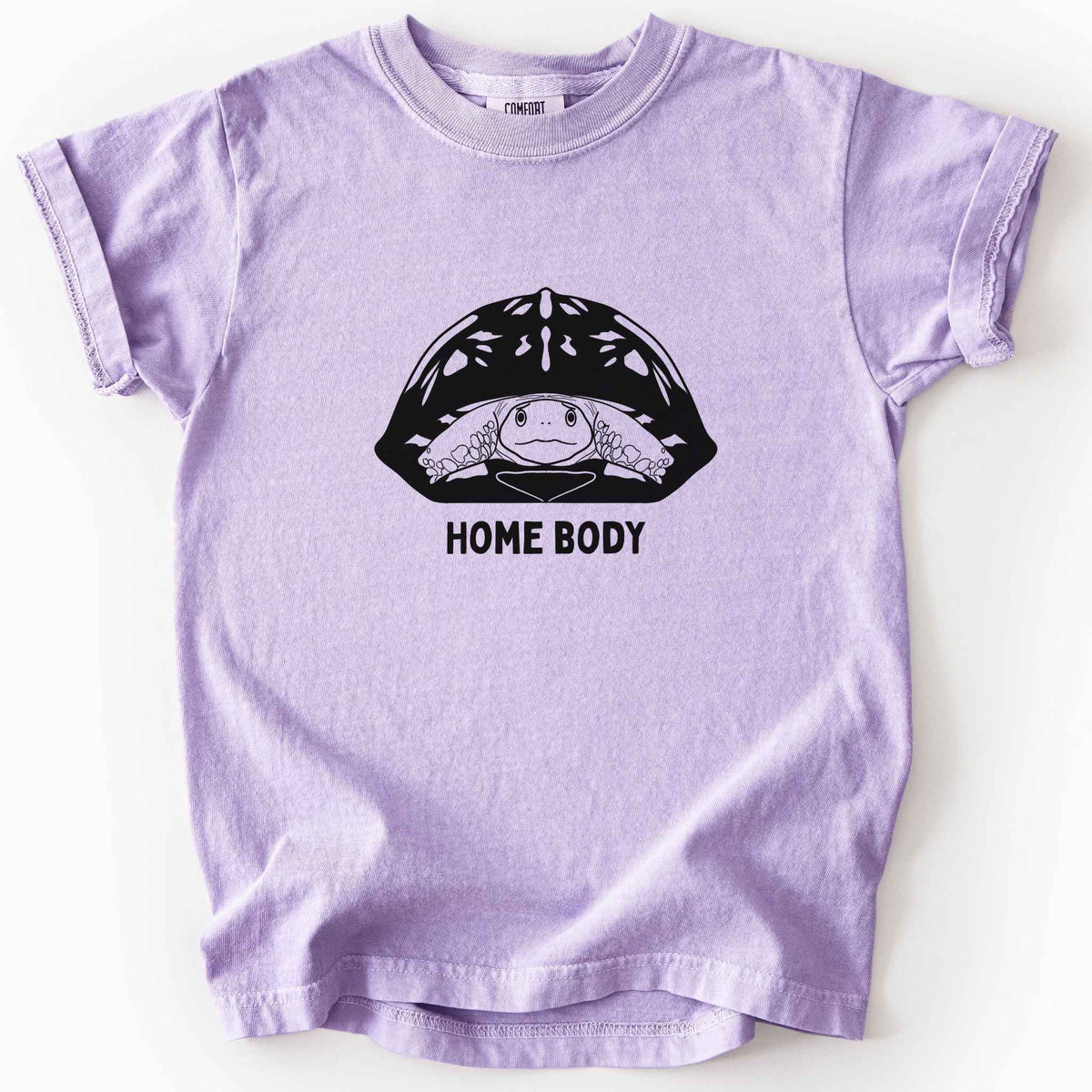 Orchid "Home Body" kids t-shirt on Comfort Colors tee, featuring a bold black graphic of a turtle peeking out from its shell above simple lettering. Funny turtle lover gift shirt for introverts and reptile enthusiasts.