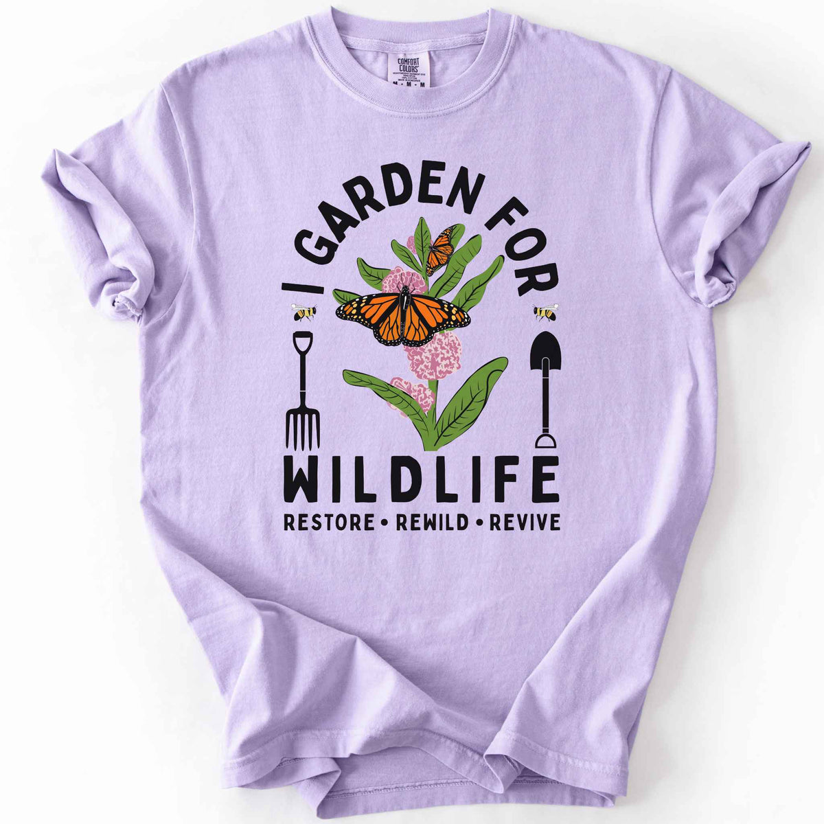 Orchid "I Garden for Wildlife, Restore, Rewild, Revive" t-shirt on Comfort Colors tee, featuring monarch butterflies and bees on milkweed flowers flanked by garden tools in orange and gold tones. Gardener and native plant gift shirt for pollinator conservation fans.