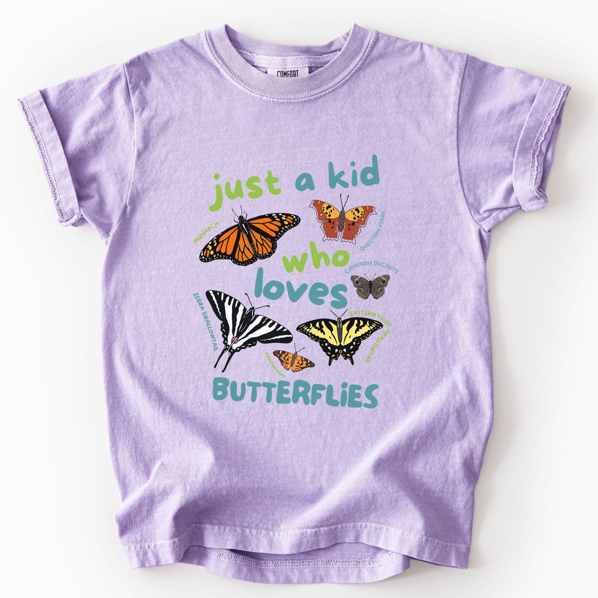 Orchid "Just a Kid Who Loves Butterflies" youth t-shirt on Comfort Colors tee, featuring six labeled butterfly species including Monarch, Zebra Swallowtail, and Painted Lady with playful green and teal lettering. Kids butterfly lover gift shirt for young nature explorers and budding entomologists.