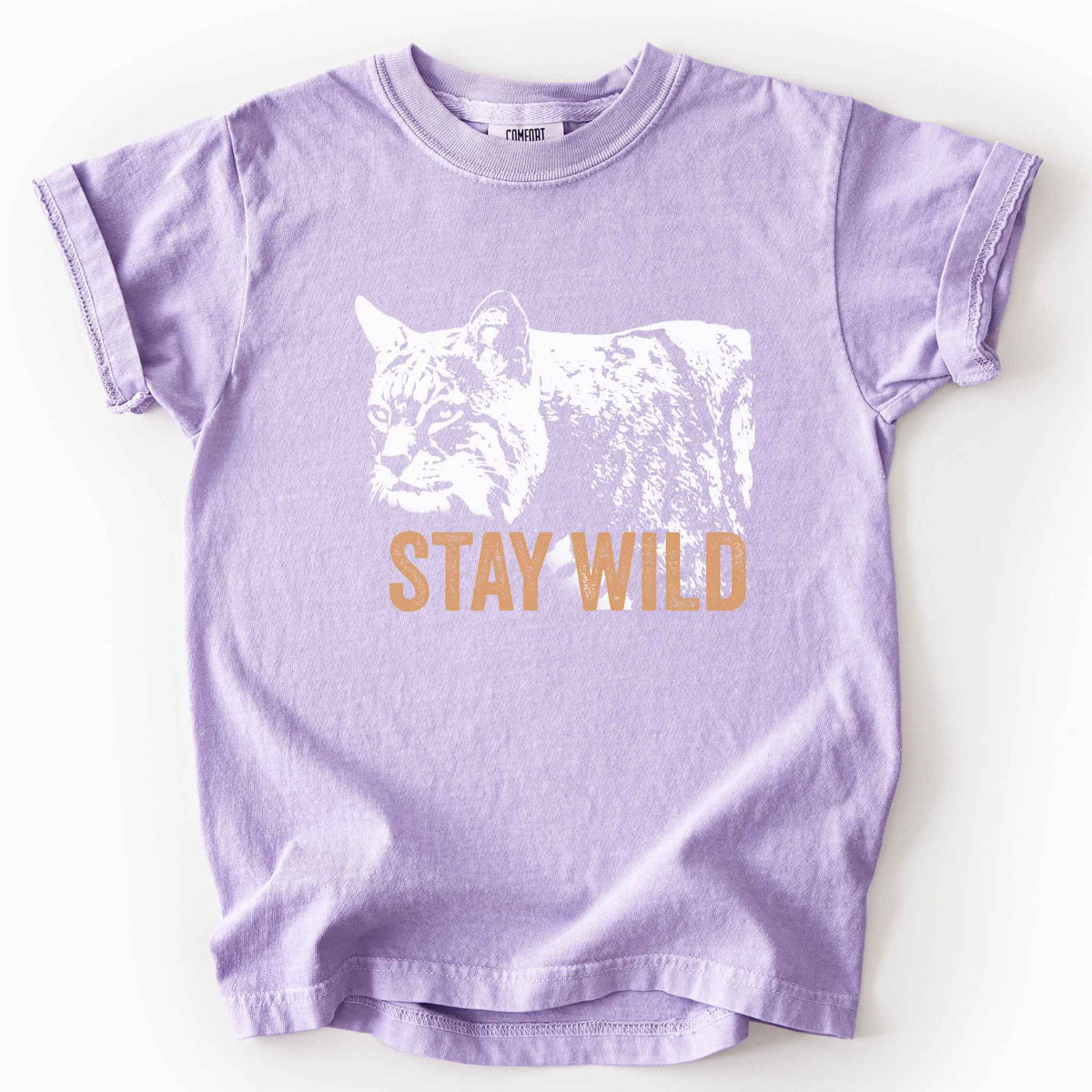 Orchid "Stay Wild" kids t-shirt on Comfort Colors tee, featuring a bold white bobcat graphic with orange lettering — wildlife lover and nature enthusiast gift shirt for outdoorsy, animal-inspired style.