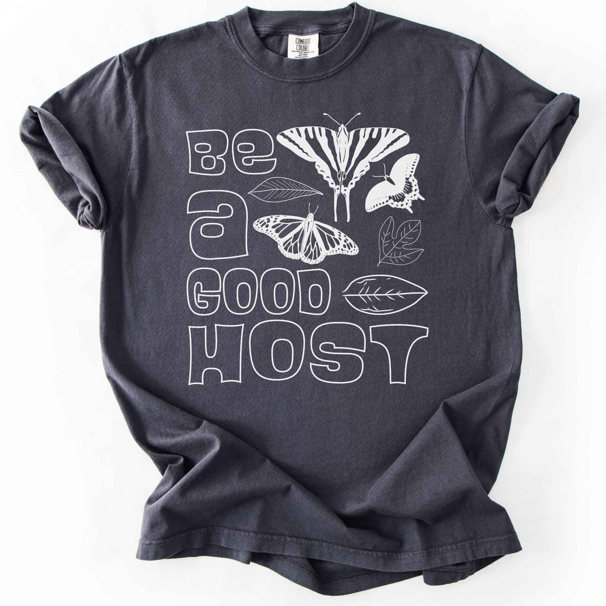 Pepper "Be a good host" t-shirt on Comfort colors with illustrations of zebra swallowtail and host plant paw paw leaf, spicebush swallowtail and one of its host plants sassafras leaf, and monarch and host plant milkweed leaf. Gift for wildlife gardeners and native plant enthusiasts.