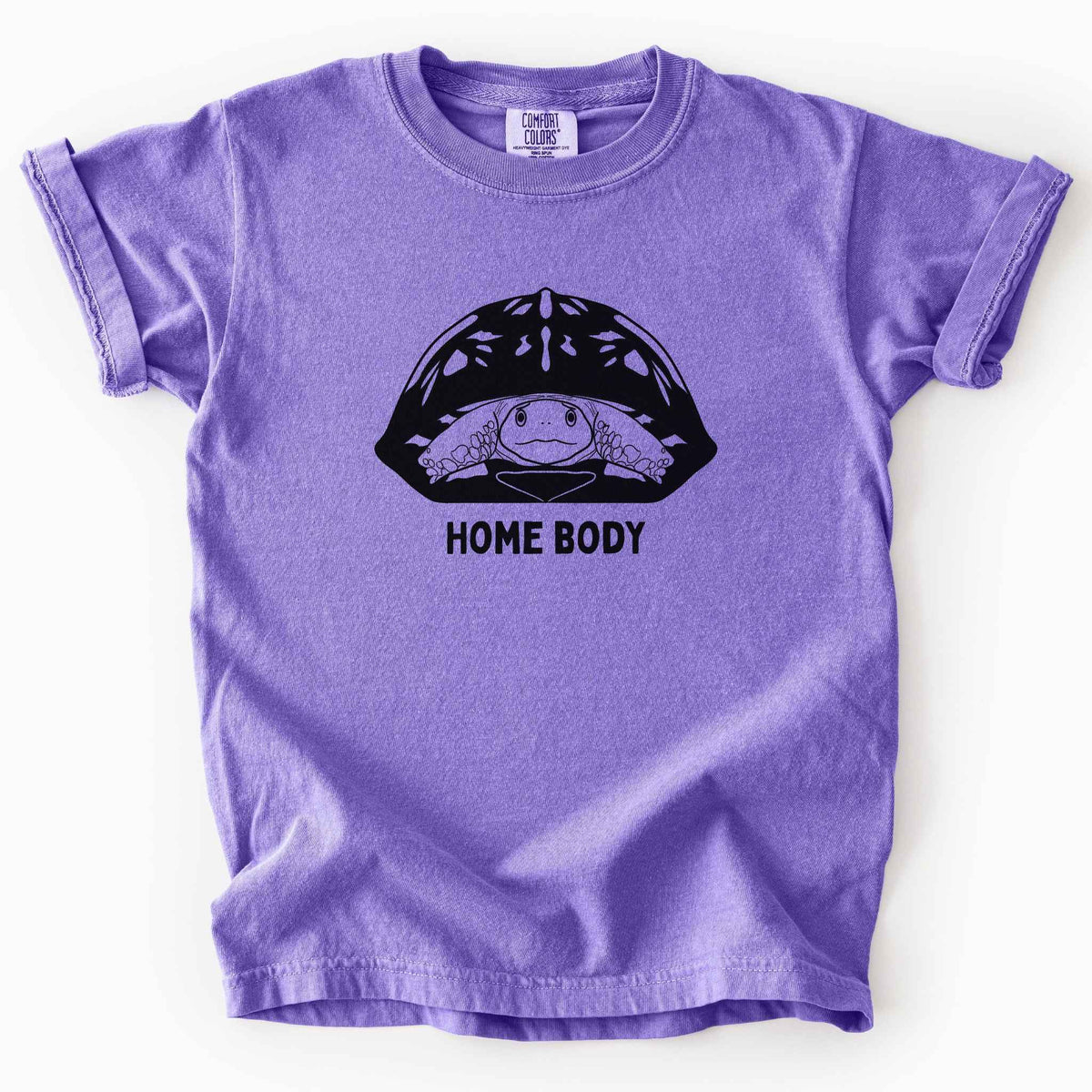 Violet "Home Body" kids t-shirt on Comfort Colors tee, featuring a bold black graphic of a turtle peeking out from its shell above simple lettering. Funny turtle lover gift shirt for introverts and reptile enthusiasts.