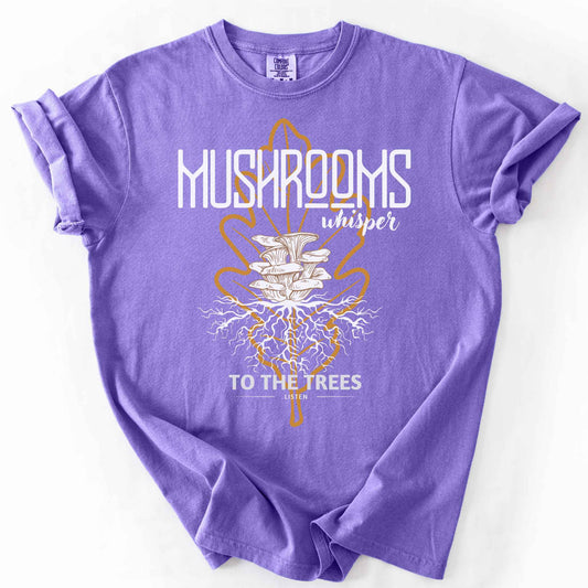 Violet "Mushrooms Whisper to the Trees, Listen" t-shirt on Comfort Colors tee, featuring mushrooms growing from a mycelium root system inside a golden leaf outline. Mycology and forest lover gift shirt for foragers and mushroom enthusiasts.