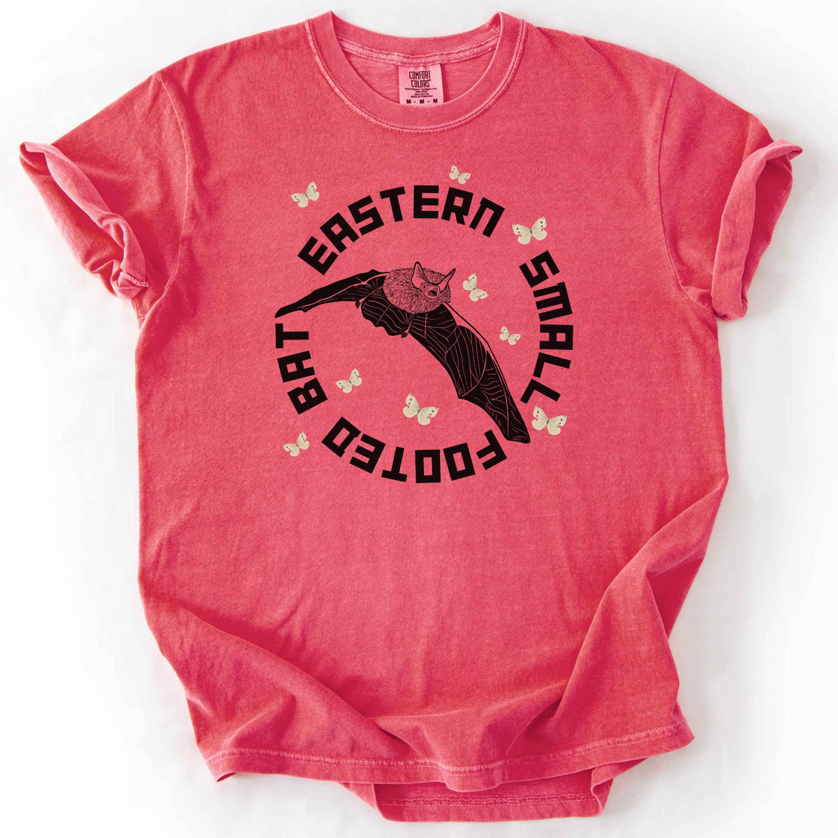 Watermelon "Eastern Small Footed Bat" t-shirt on Comfort Colors tee, featuring a black illustration of a flying bat surrounded by pale moths in a circular badge design. Bat lover and wildlife gift shirt for nocturnal animal and nature enthusiasts.