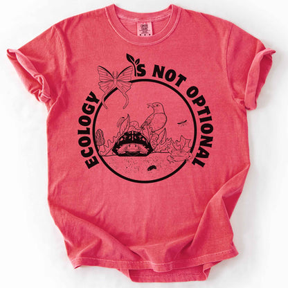 Watermelon "Ecology Is Not Optional" t-shirt on Comfort Colors tee, featuring a black circle badge with a box turtle, bird, luna moth, frog, and mushrooms in an ecosystem scene. Nature lover and biology gift shirt for ecologists and conservation enthusiasts.
