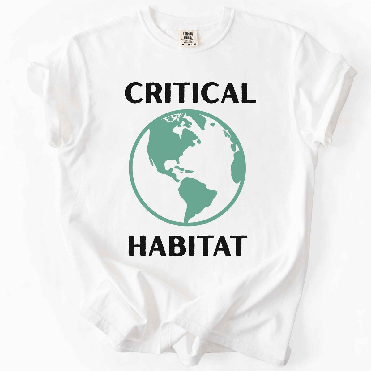 White "Critical Habitat" t-shirt on Comfort Colors tee, featuring a bold green globe graphic with black lettering. Conservation and environmentalist gift shirt for earth science and wildlife protection advocates.