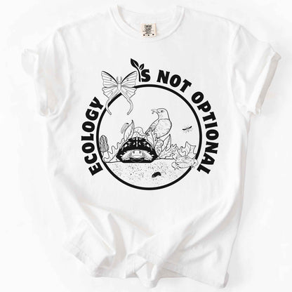 White "Ecology Is Not Optional" t-shirt on Comfort Colors tee, featuring a black circle badge with a box turtle, bird, luna moth, frog, and mushrooms in an ecosystem scene. Nature lover and biology gift shirt for ecologists and conservation enthusiasts.