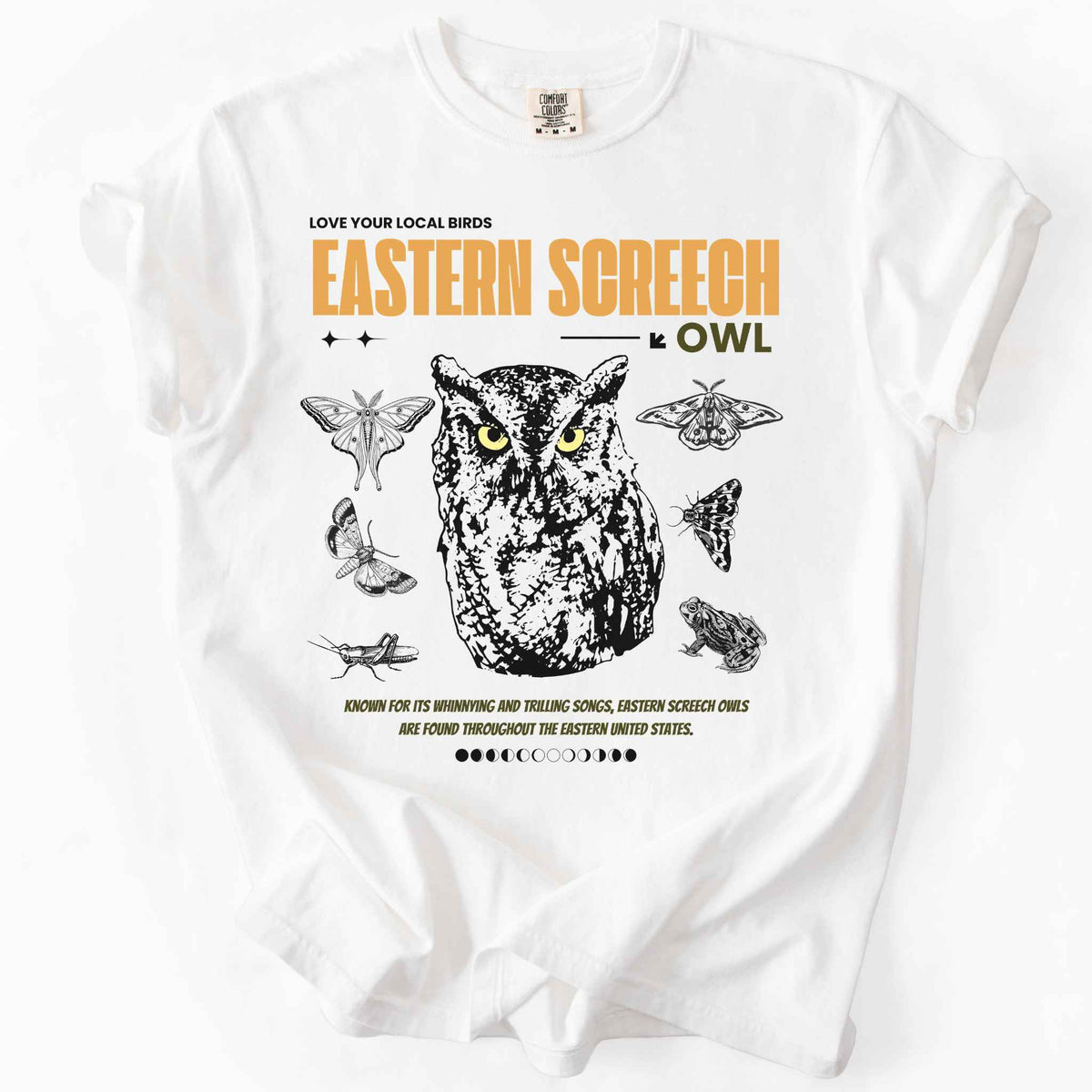 White "Love Your Local Birds, Eastern Screech Owl" t-shirt on Comfort Colors tee, featuring a detailed owl portrait surrounded by moths, a frog, and a grasshopper with orange lettering and educational text. Birdwatcher and owl lover gift shirt for wildlife and nature enthusiasts.