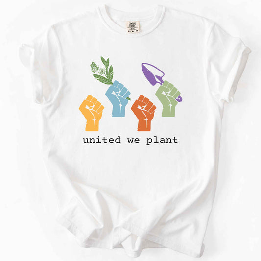 White "United We Plant" t-shirt on Comfort Colors tee, featuring four colorful raised fists, one holding a plant sprig and another a garden trowel, above bold black text. Gardener and native plant gift shirt for community garden and conservation enthusiasts.