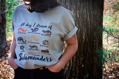 Woman in Salamander Tshirt with trees in the background.
