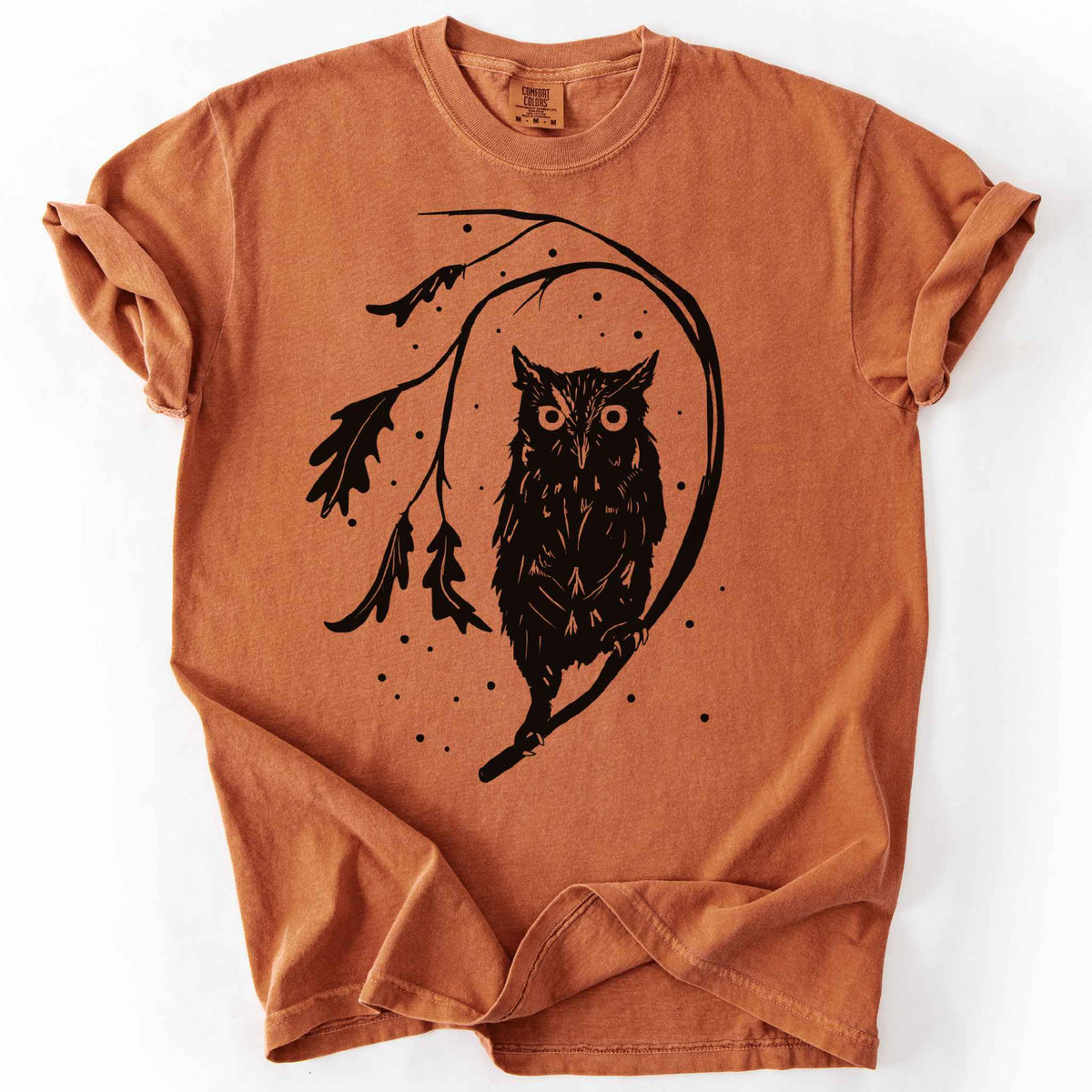 Yam "Eastern Screech starry night" owl t-shirt on Comfort Colors tee, featuring a bold black illustration of a screech owl perched on a leafy branch with scattered dots for stars. Birdwatcher and owl lover gift shirt for wildlife and nature enthusiasts.